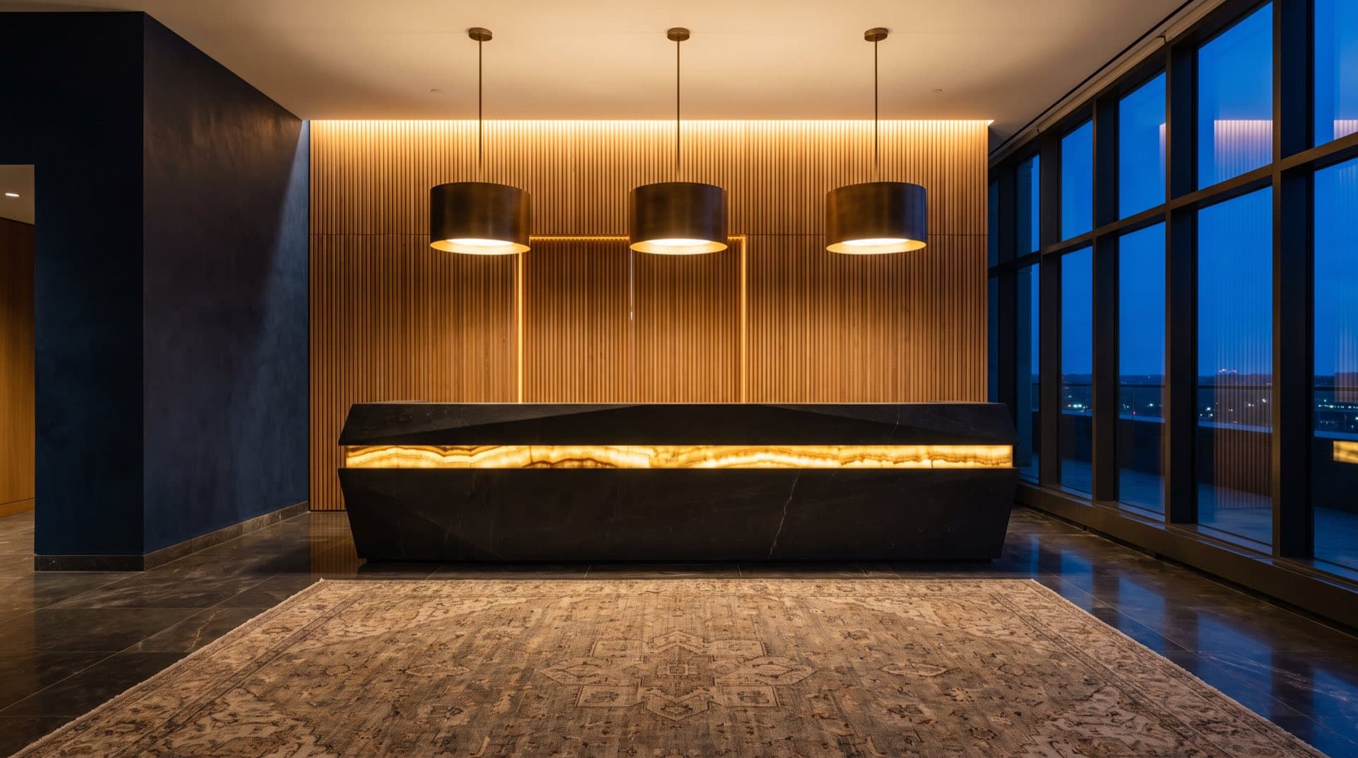 Hotel reception desk in dark stone against an oak slatted wall