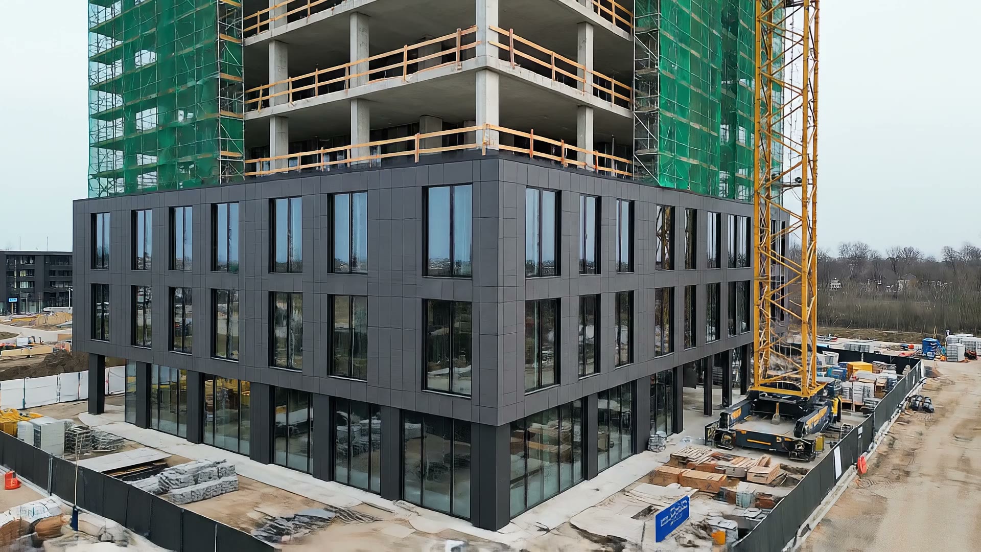A hotel under construction, upper floors still bare concrete